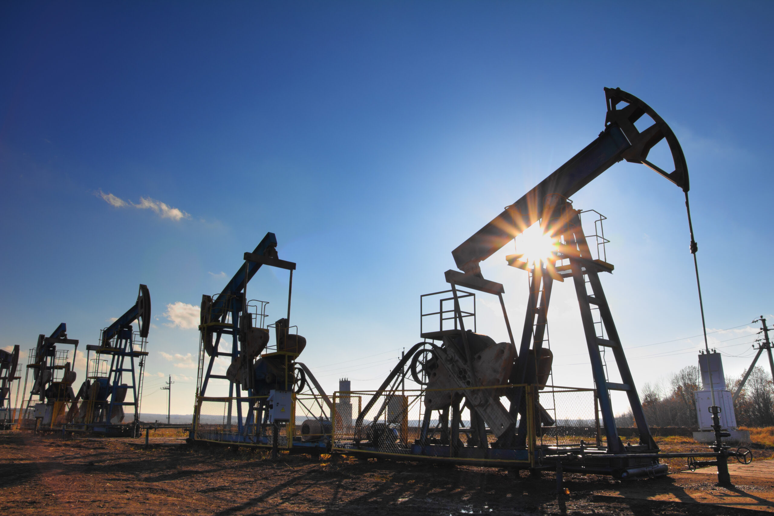 Working,Oil,Pumps,Silhouette,Against,Sun Sector Oil & Gas